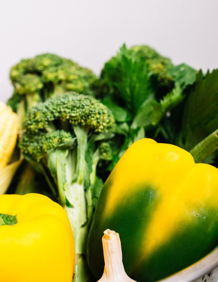 who-we-are A vibrant collection of fresh organic vegetables including broccoli, bell peppers, celery, and garlic.